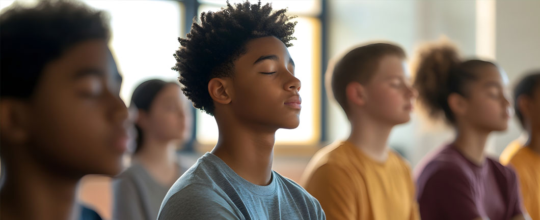 Group of teens meditating for international stress awareness day and therapy at Aris Clinic.