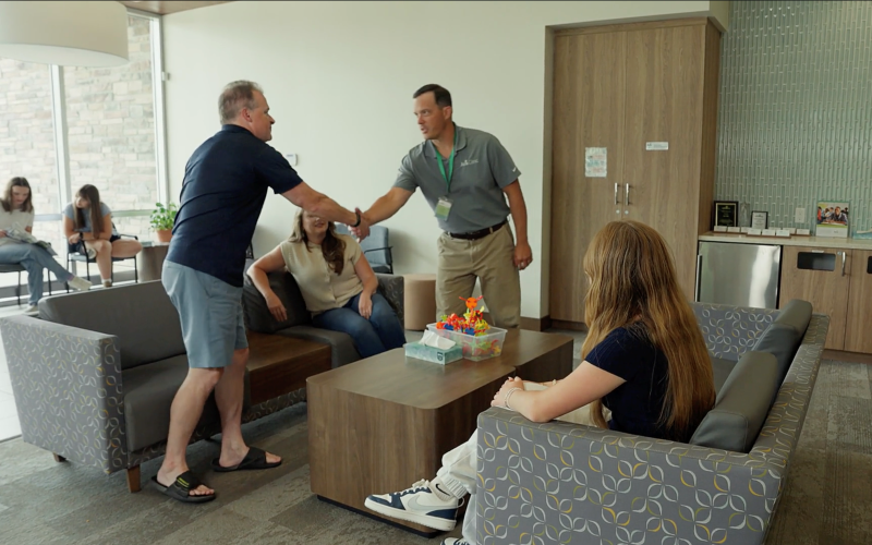 A referred family arrives at Aris Clinic, connecting with staff in a welcoming, supportive environment designed for personalized mental health care and guidance.