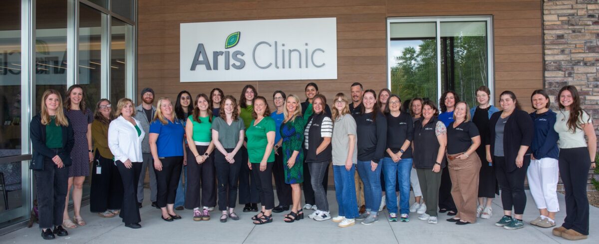 Aris Clinic team gathered outside the Woodbury clinic to celebrate 15 years of helping children and families.